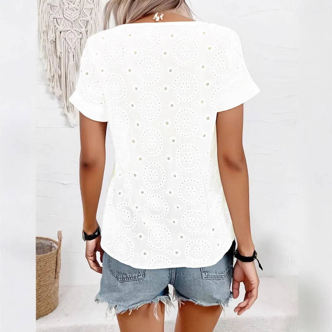 White loose V-neck t-shirt with hollow-out pattern detail on front, short sleeves, casual fit.