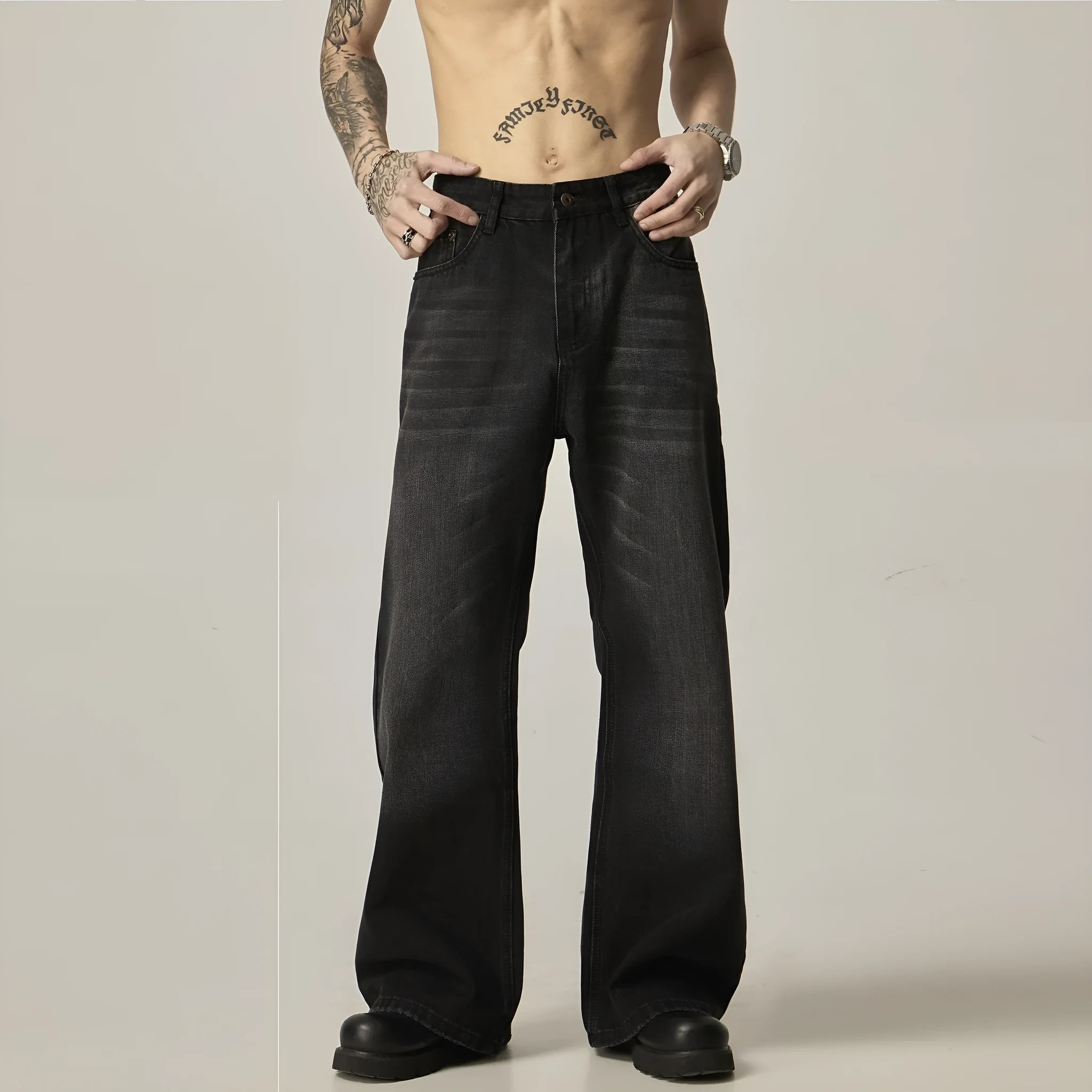 Black loose-fit straight leg denim jeans with a zipper fly on a neutral background.