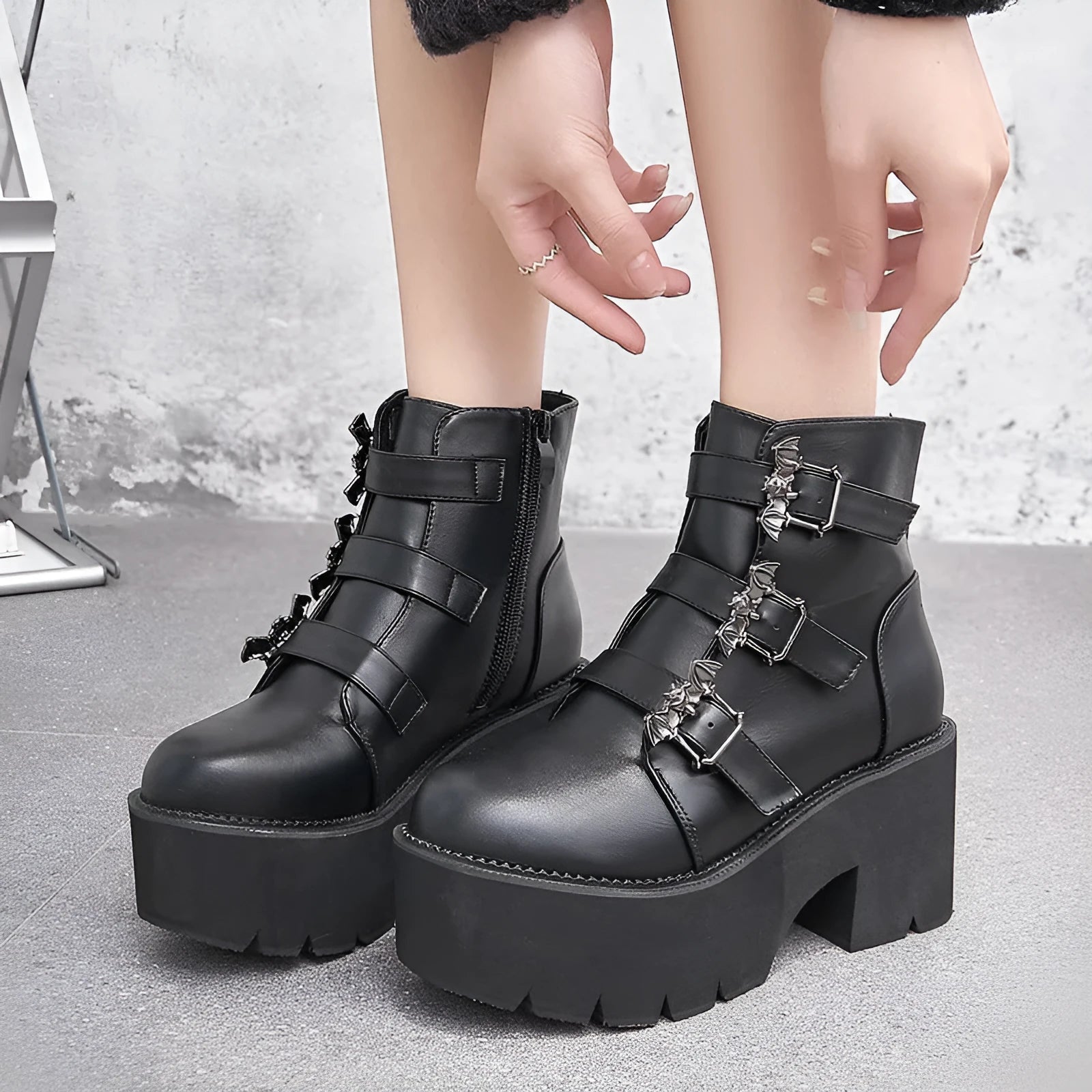 Black women's punk gothic Martin boots with bat buckle and side zip.