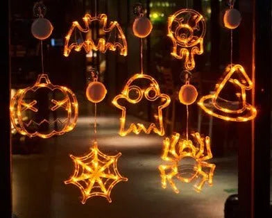 Halloween LED window lights with suction cups showing ghost, spider, and pumpkin decorations