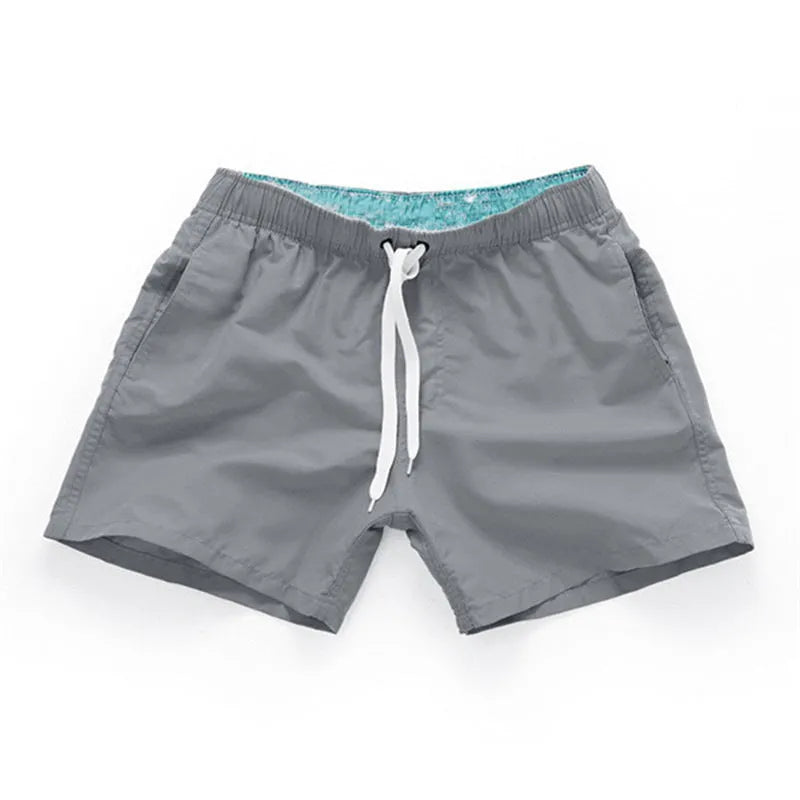 Men's straight leg beach shorts in polyester fabric available in multiple colours and sizes