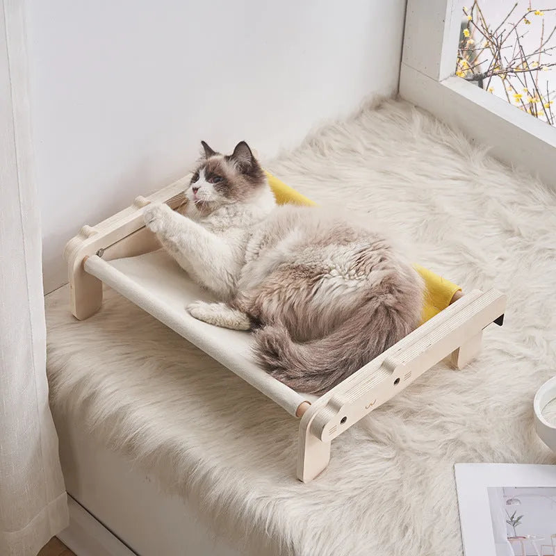 Solid wood cat bed with a removable fabric cover in a grey pink colour.