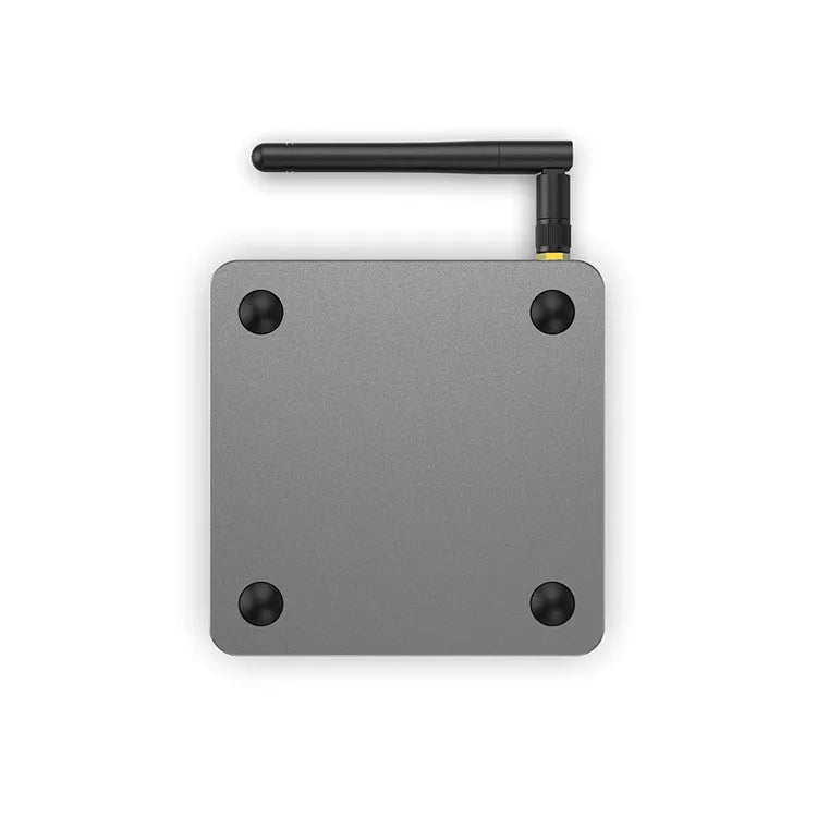 Android Smart TV set-top box with voice remote, HDMI cable, and power adapter on a table.