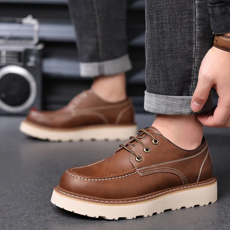 Men's black low-top retro Martin boots with a round toe and non-slip rubber sole.