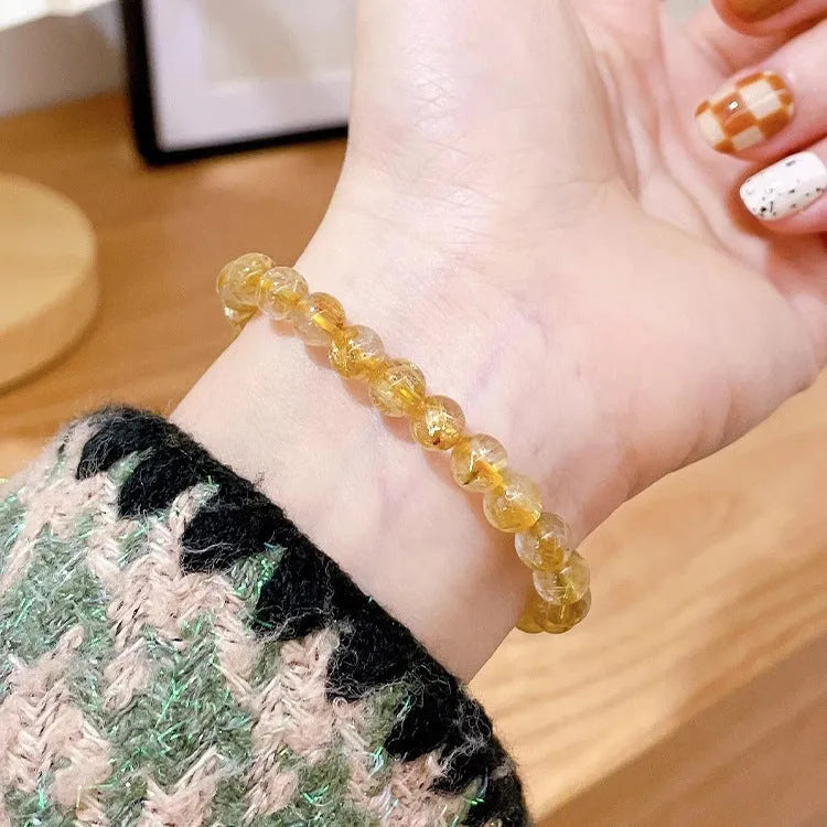 Handmade natural gold rutilated quartz and sunstone crystal bracelet with round diamond-shaped elements
