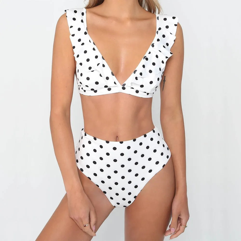 Black and white polka dot women's bikini set with a deep V-neck top and ruffled trim.