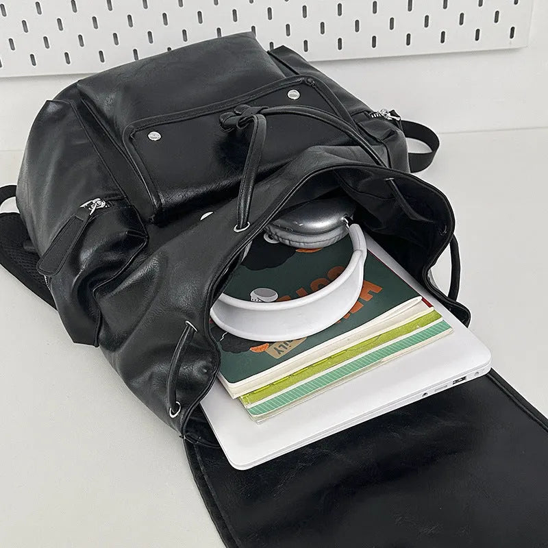Solid colour PU couple travel backpack in black, curved shoulder strap, waterproof design for leisure travel