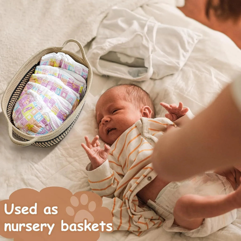 Light beige handmade woven cotton rope storage basket with a wooden handle on a wooden floor.