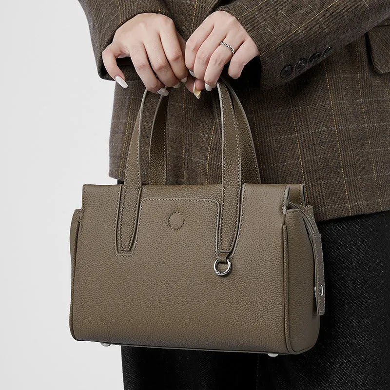 Genuine leather crossbody bag in horizontal square design with single strap, shown in black colour option.