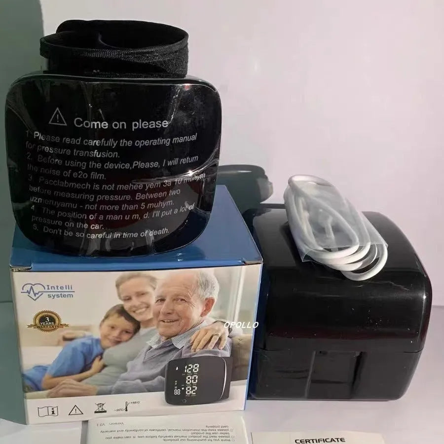 Black wrist blood pressure monitor with USB charging cable.