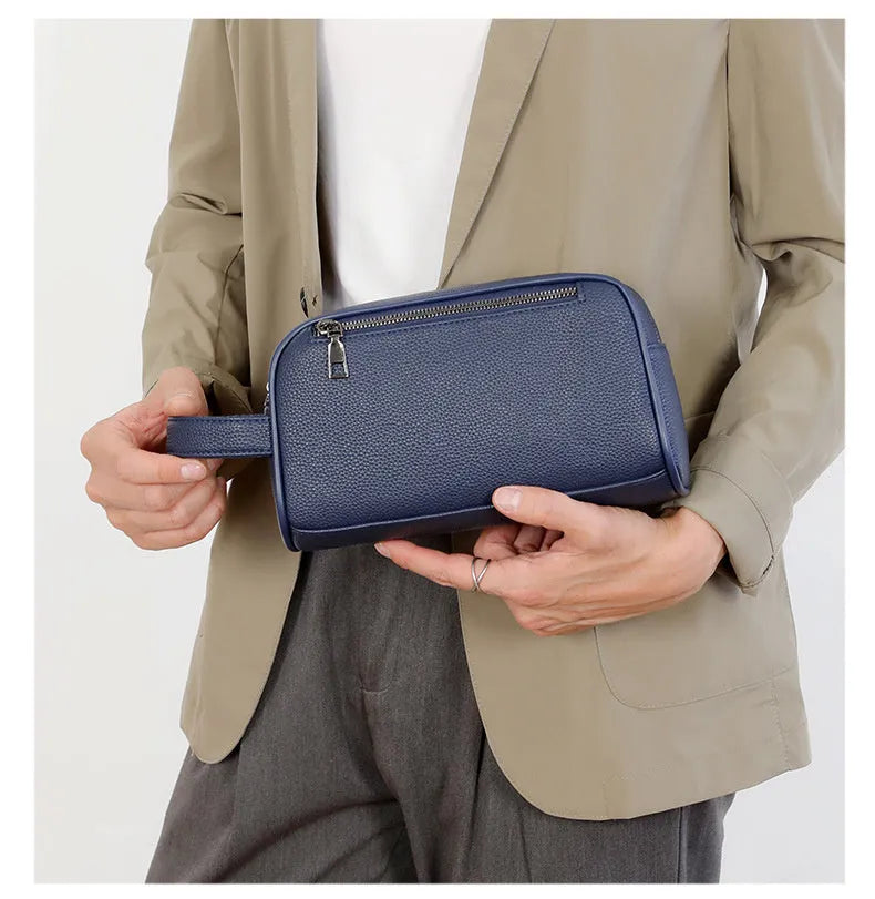 Men's business clutch bag in soft PU leather with large capacity, solid colour finish and zip closure, available in black, dark blue and brown