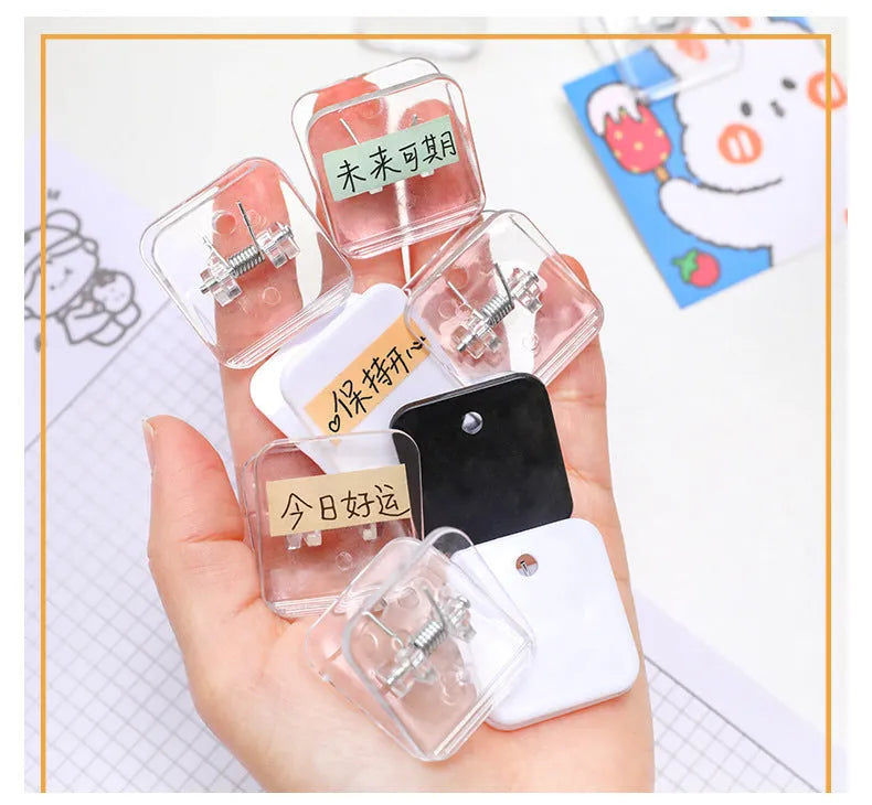Set of five small square plastic note holders in white, black, and transparent colours