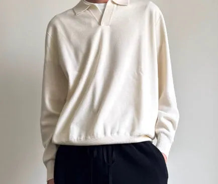 Man's pure wool polo sweater with lapel collar in loose fit, shown in milky white.