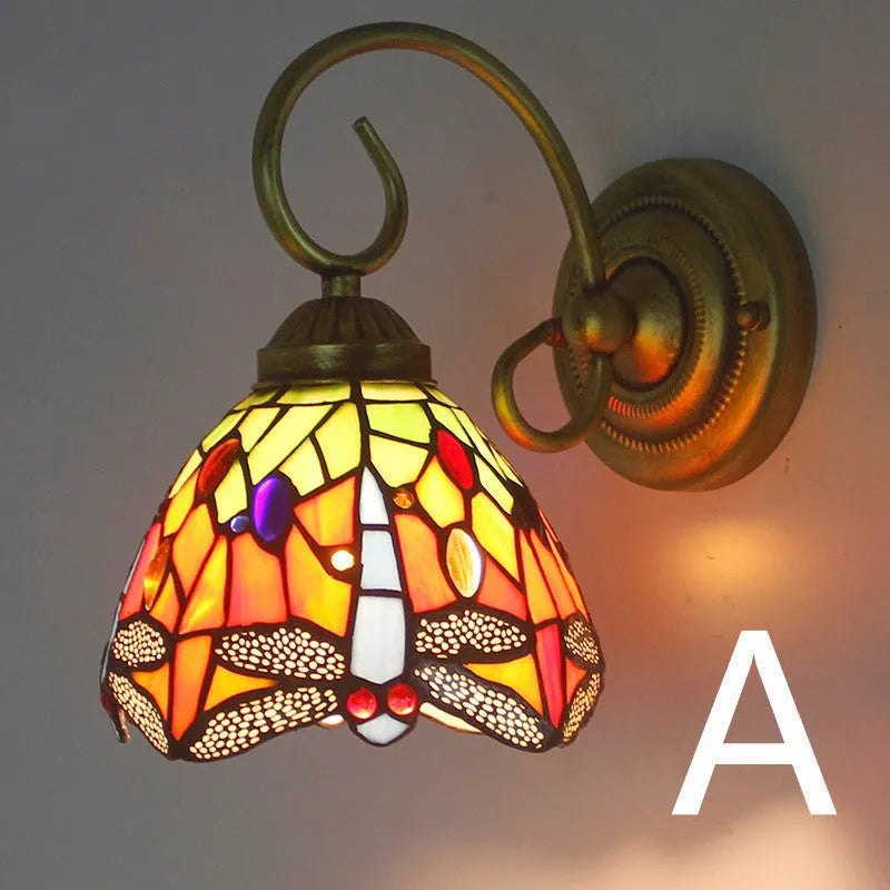 A coloured stained glass wall lamp in a simple contemporary style, mounted on a wall.