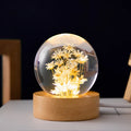 3D dandelion inside a clear resin crystal ball night light on a beech wood stand.