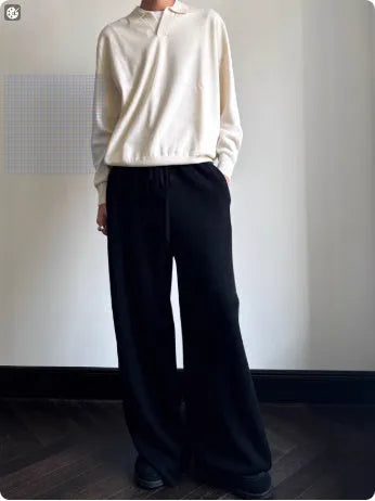 Man's pure wool polo sweater with lapel collar in loose fit, shown in milky white.