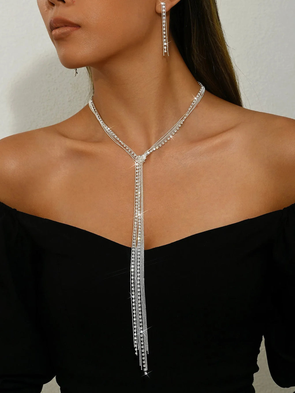 Silver curb chain necklace with rhinestone pendant and matching long earrings in a three-piece set for women