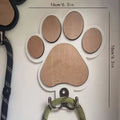 Wooden foot paw print wall hook in black on a white background, showing its shape and design.