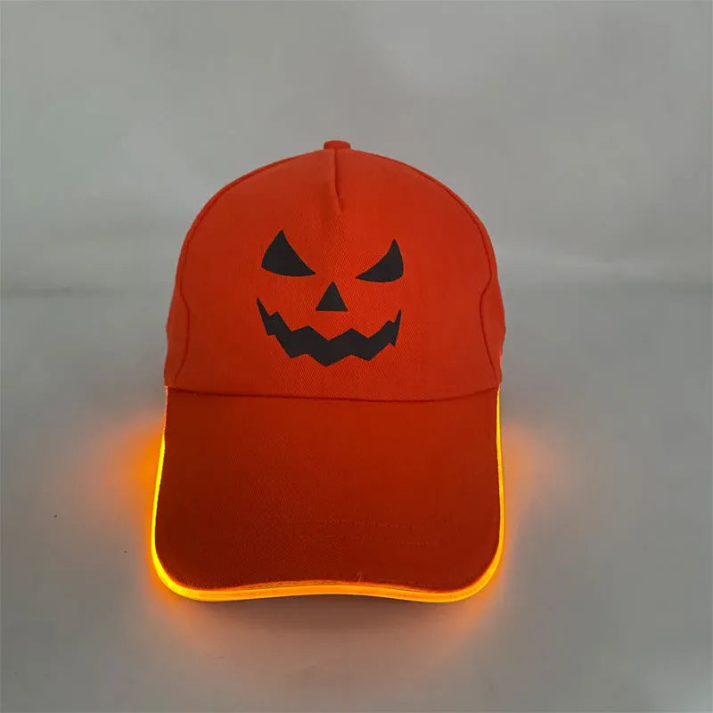 Black Halloween baseball cap with LED pumpkin smile face and yellow lights illuminated.