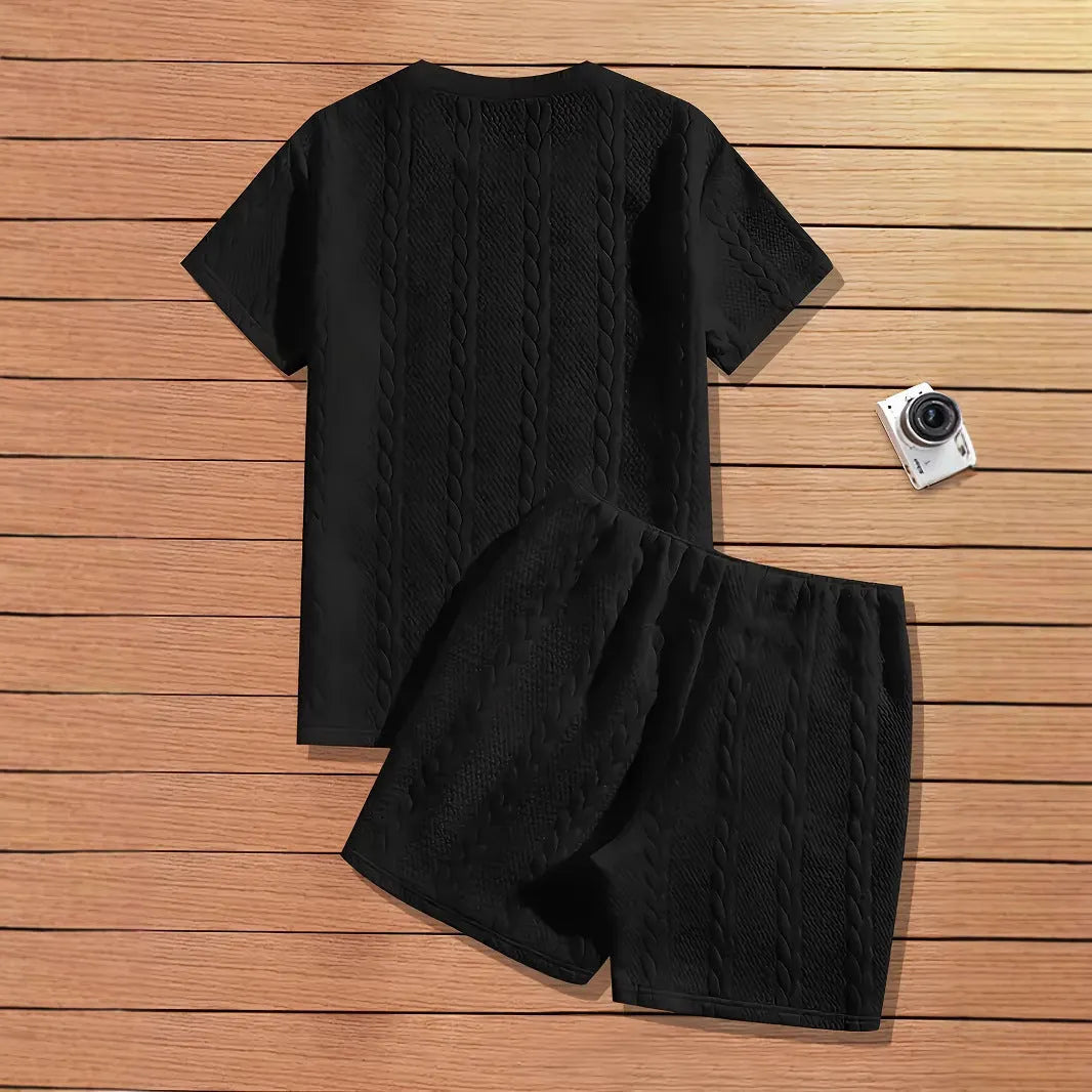 Men's black sports two-piece set with ribbed short sleeve top and matching trousers for athletic activities