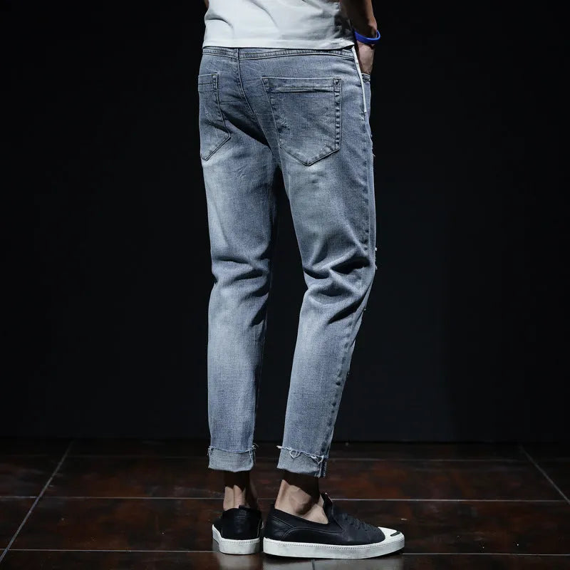 Light blue ripped jeans with straight leg, mid waist, and cropped length for youth