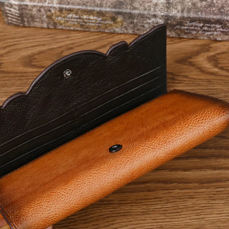Retro brown tri-fold women's wallet with embossed floral pattern, showing card slots and folded profile.