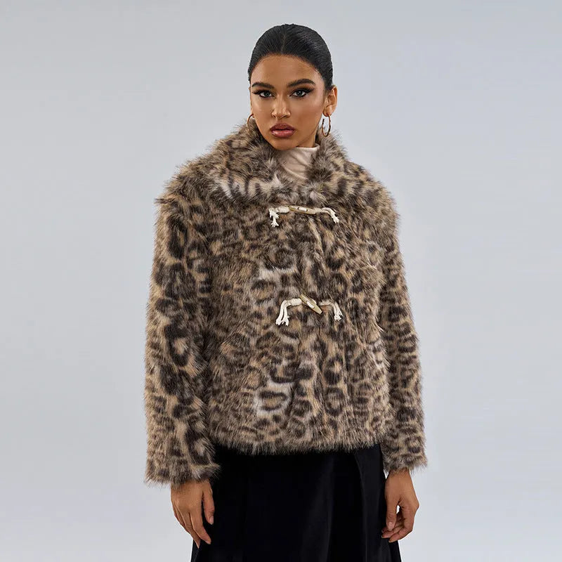 Women's leopard print coat with a buckle lapel closure on a street fashion model.