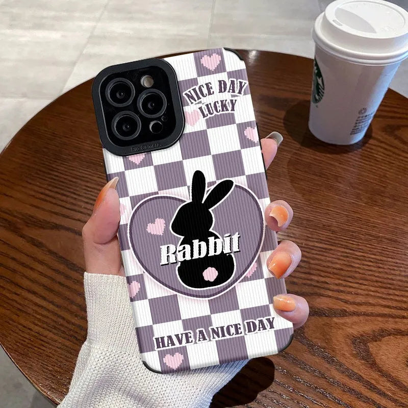 Cartoon creative TPU phone case with checkerboard bunny design on an iPhone 14, in wave black colour