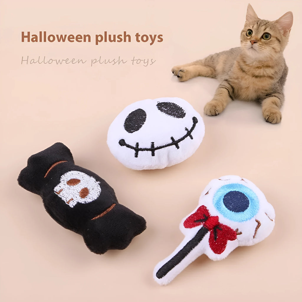 Small plush cat teaser wand with colourful eyes, candy and skull shaped attachments