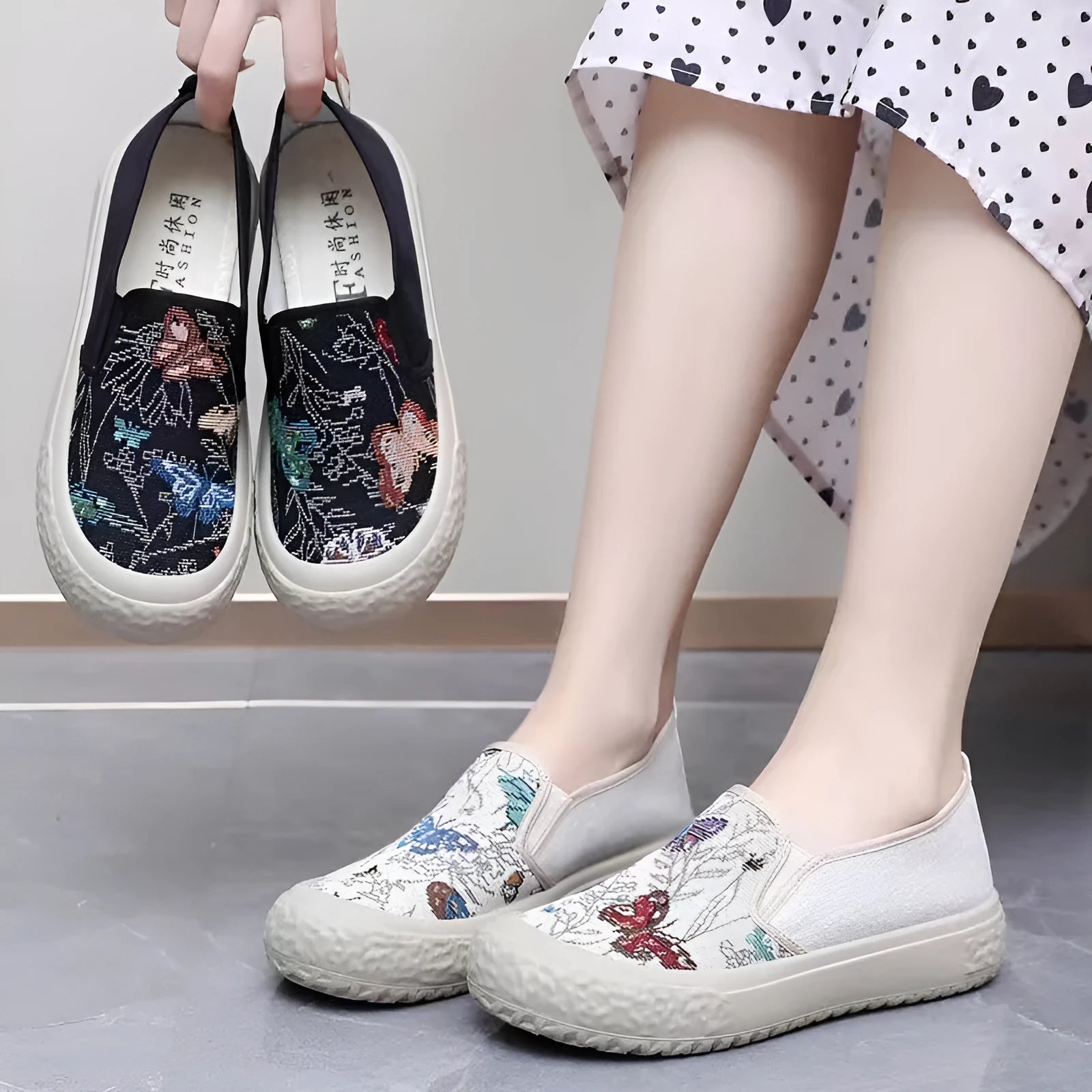 Women's black and white canvas slip-on shoes with round toe and decorative stitching.
