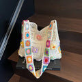 Women's large woven hollow beach shoulder bag in khaki colour showing texture and strap