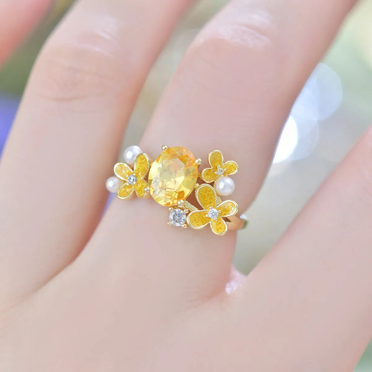 Women's flower pearl zircon open ring showing adjustable opening and electroplated metal construction
