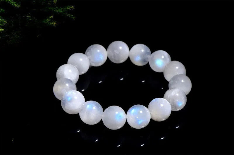 Natural white Blue Moonlight Moonstone round bead bracelet on wrist, showing polished gemstone beads.