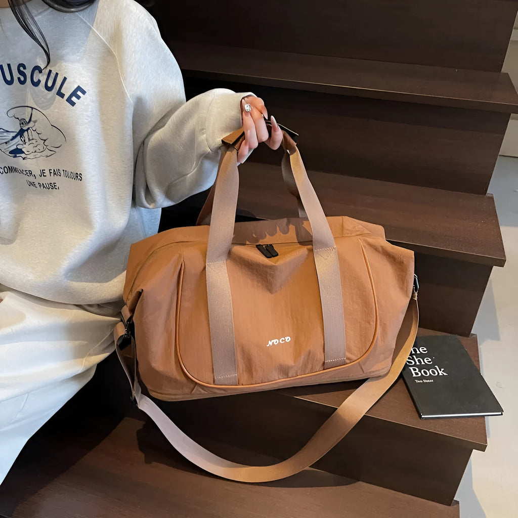 A milky white Oxford cloth crossbody bag for yoga and fitness, shown in a one-shoulder carry style.