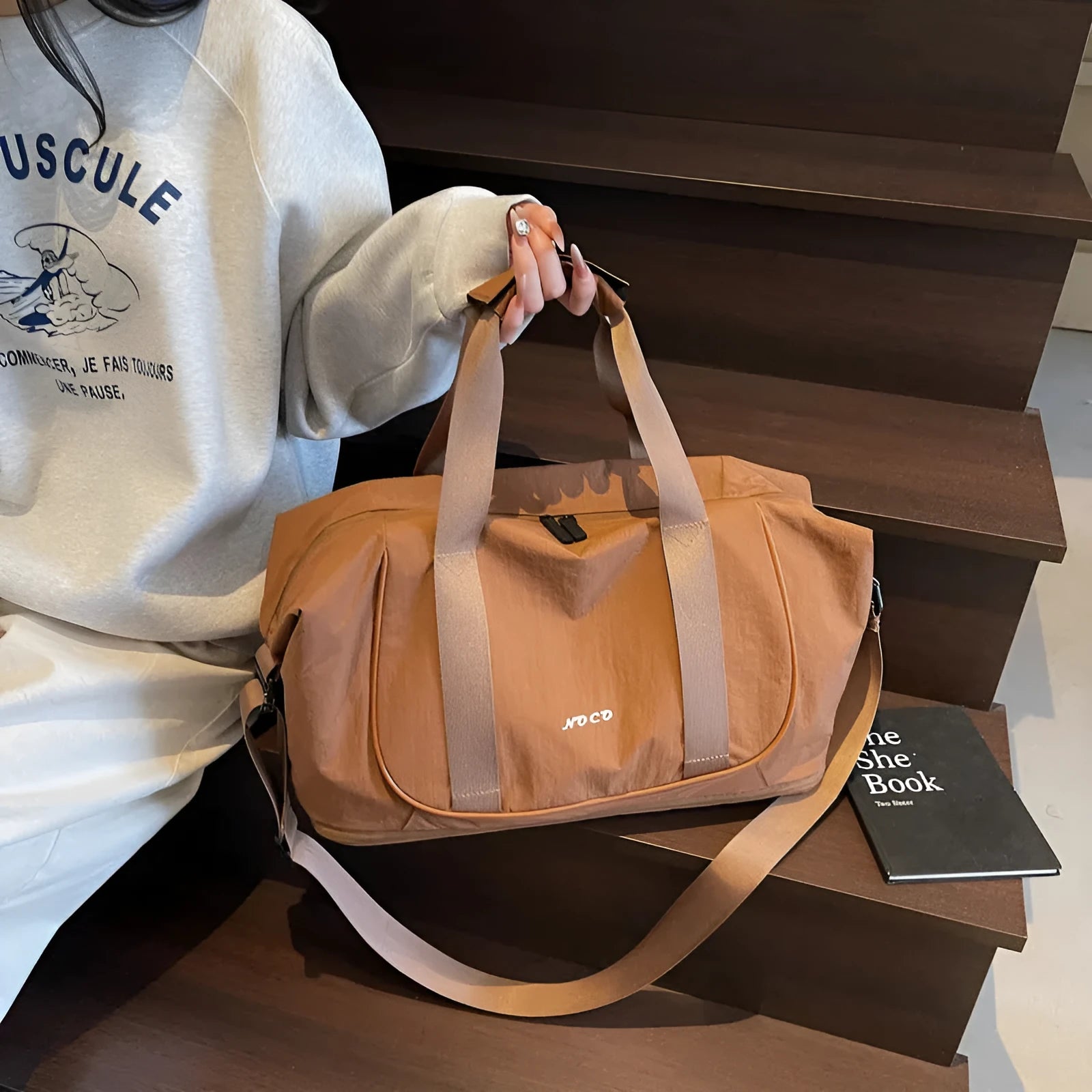 A milky white Oxford cloth crossbody bag for yoga and fitness, shown in a one-shoulder carry style.