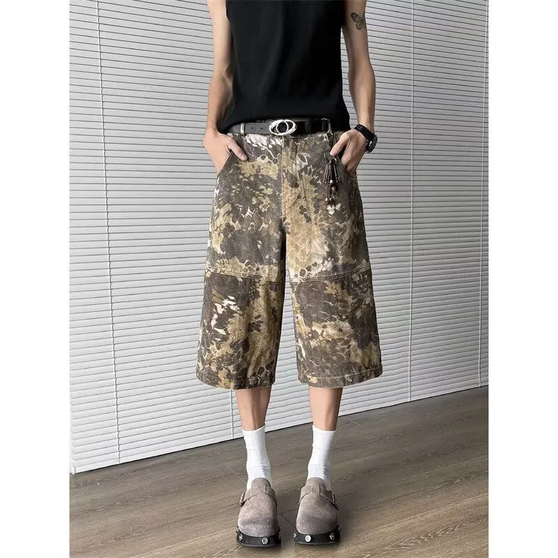 Yellow denim jeans with snake camouflage print and cropped leg length.