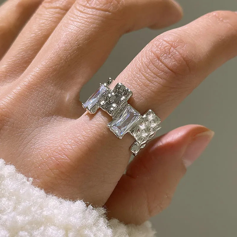 Silver geometric ring with cross zircon design and open gemstone setting