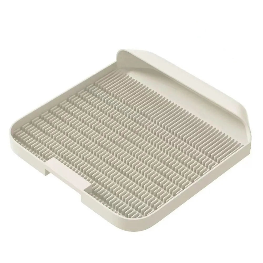 Large black cat litter pedal with slanted design and textured surface for litter containment