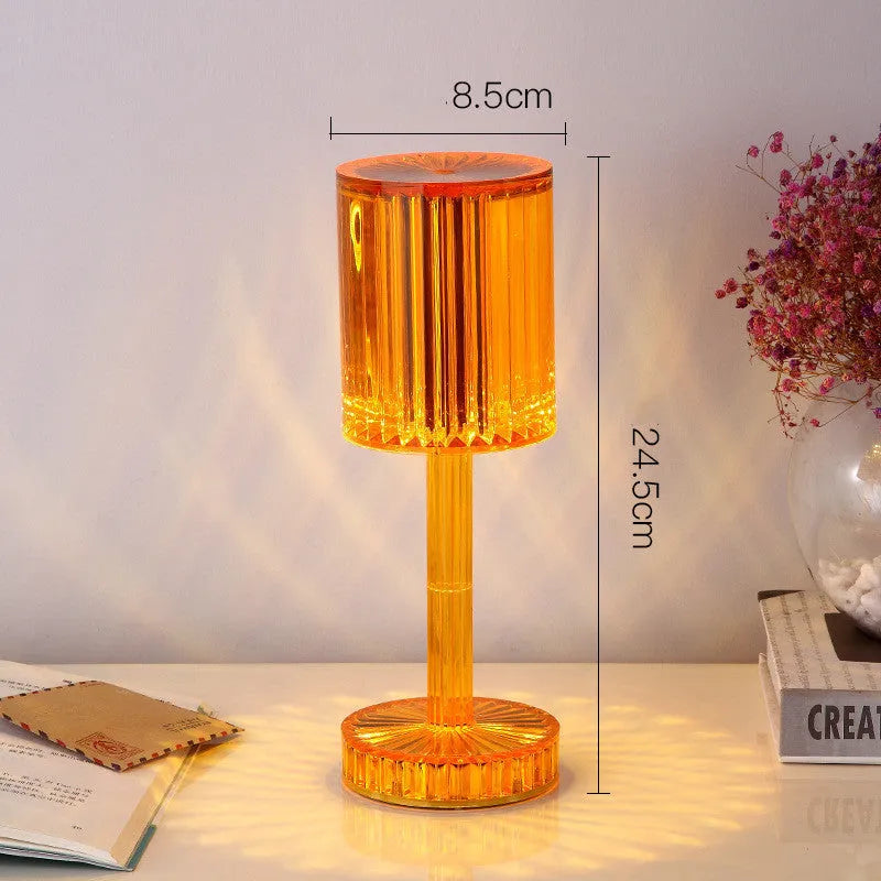 Modern crystal table lamp with a diamond-faceted shade on a metal stand, showing amber colour option.
