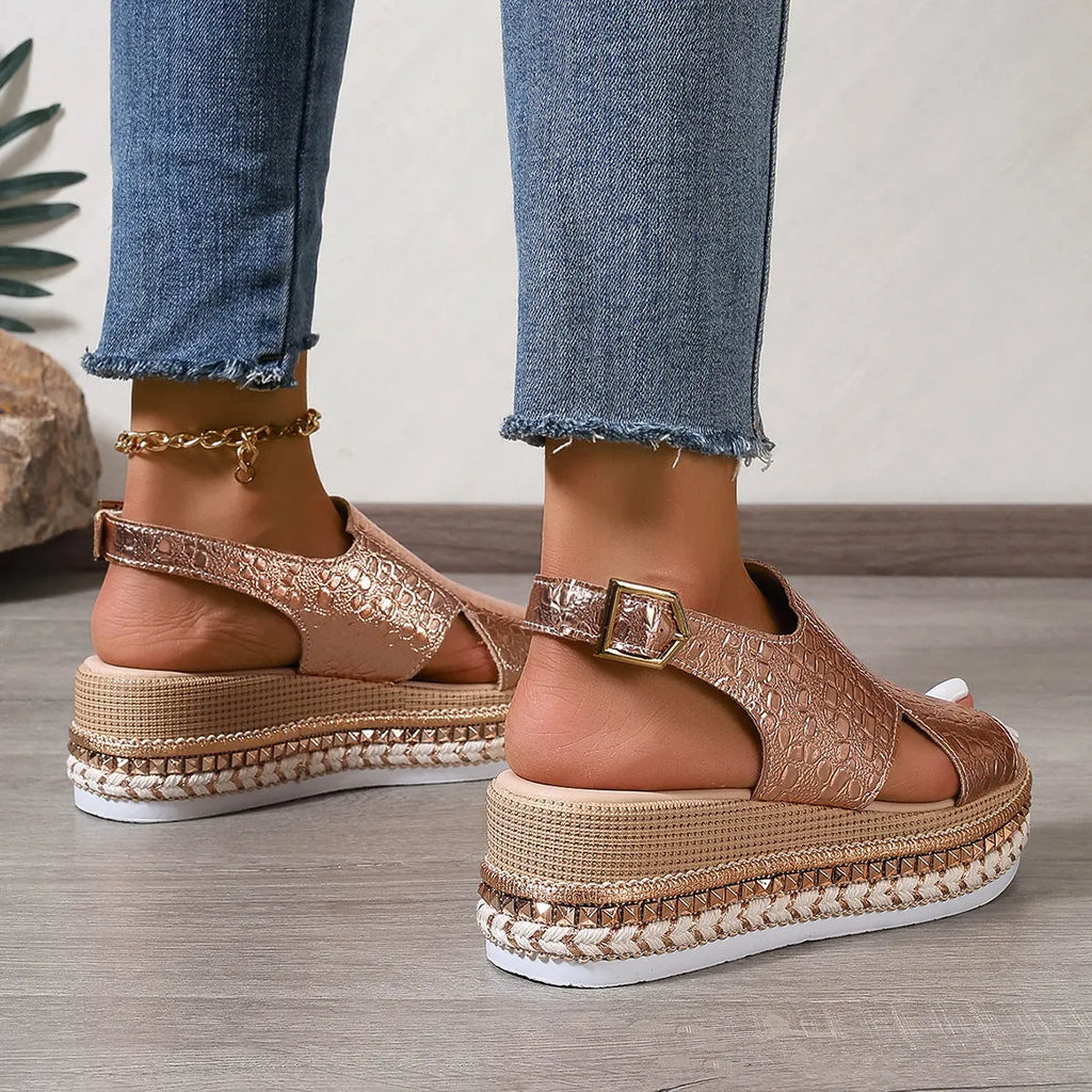 Gold women's Roman sandals with hollow-out design and an ankle buckle fastening.