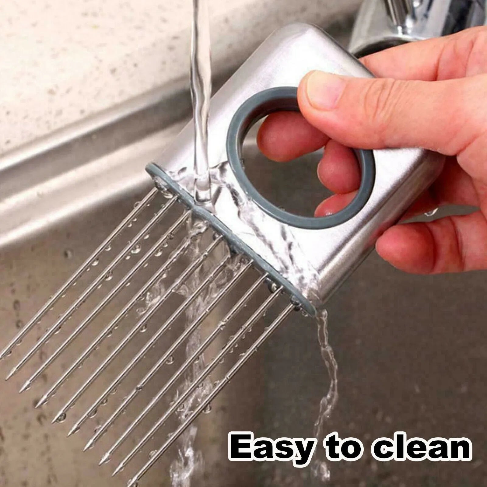 Stainless steel onion holder slicer with sharp prongs and a separate finger guard on a kitchen counter.
