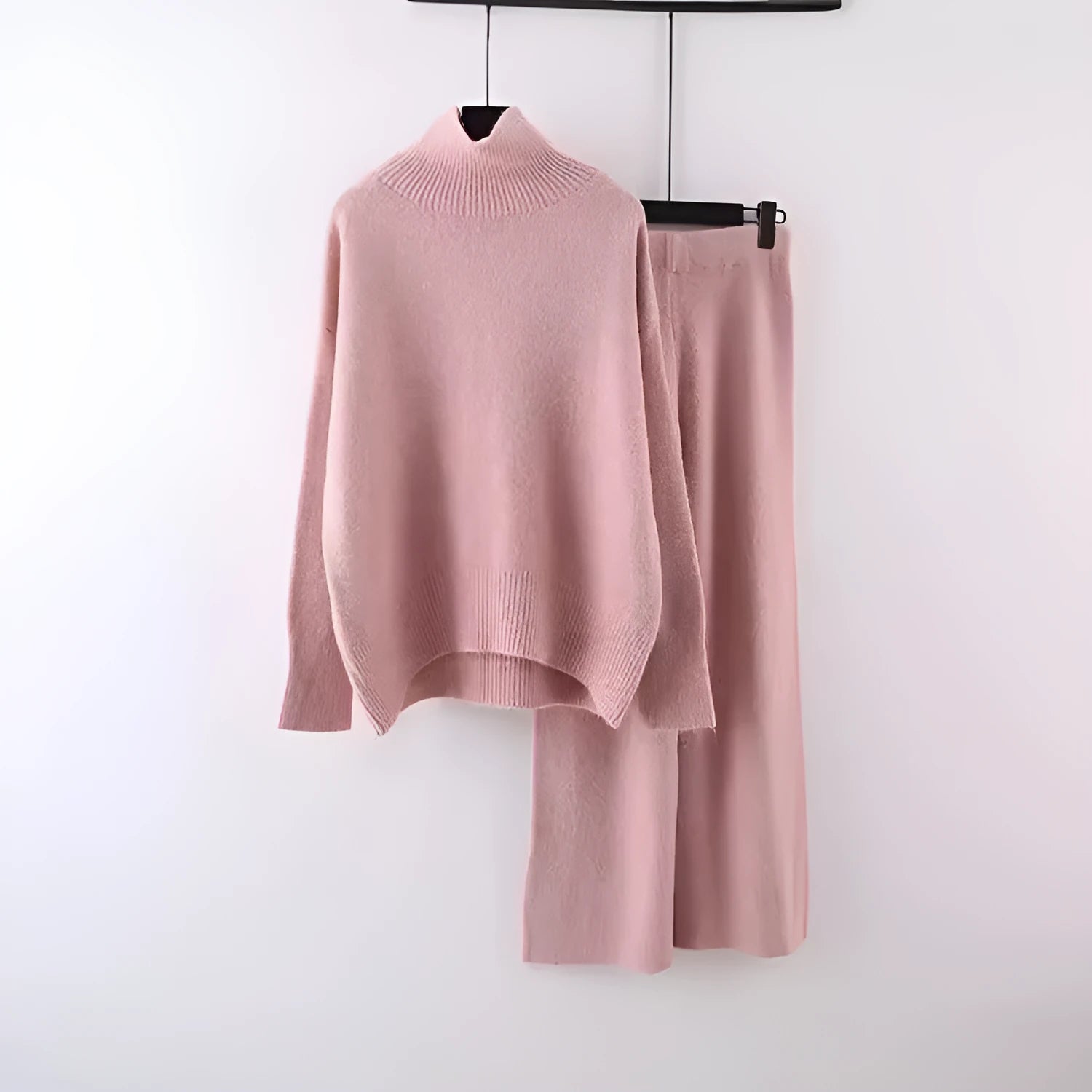Women's beige acrylic sweater and wide-leg trousers two-piece set laid flat.