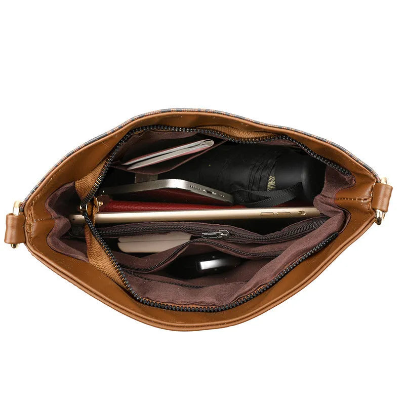 Brown retro messenger bag with soft leather texture showing interior phone and file compartments