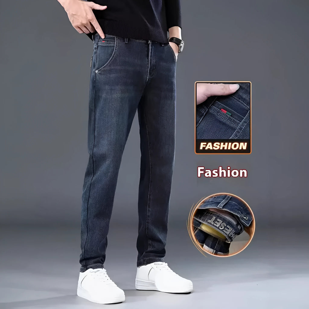 Man wearing slim straight blue grey casual trousers with a zipper fly and mid waist.