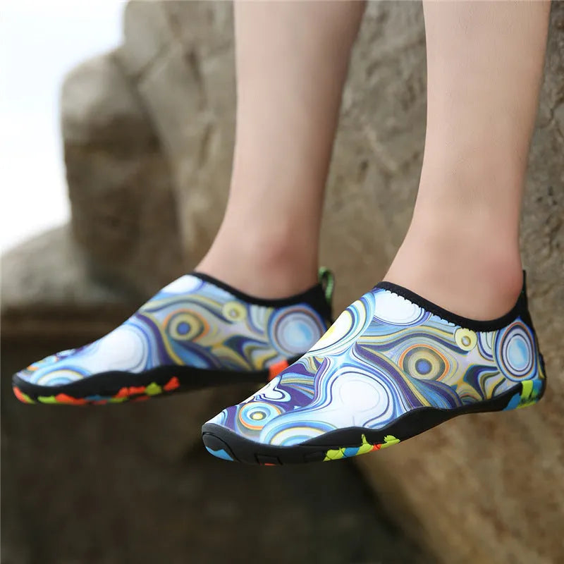 Blue leak-proof beach wading shoes with Lycra upper for men and women on a sandy background