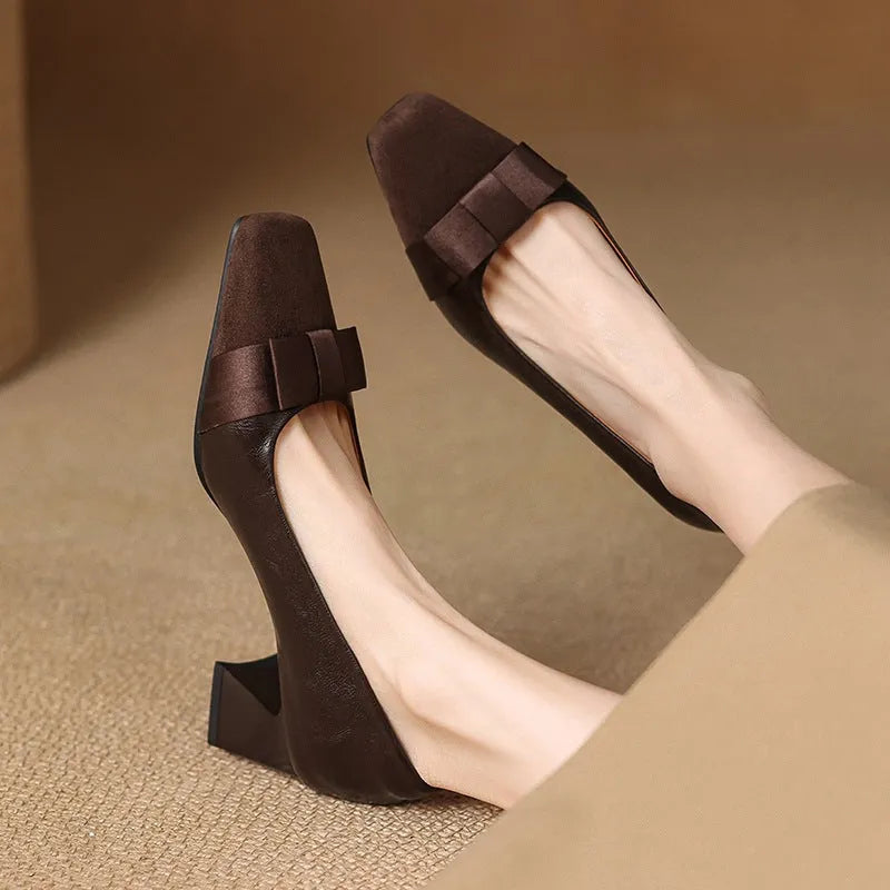 Retro square toe chunky heel pumps for women in black, with bow detail and low-cut design on a light background
