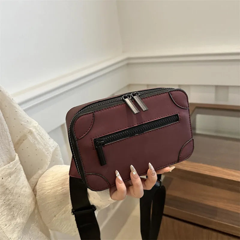 Women's black PU leather square crossbody bag with adjustable strap and outer pocket.