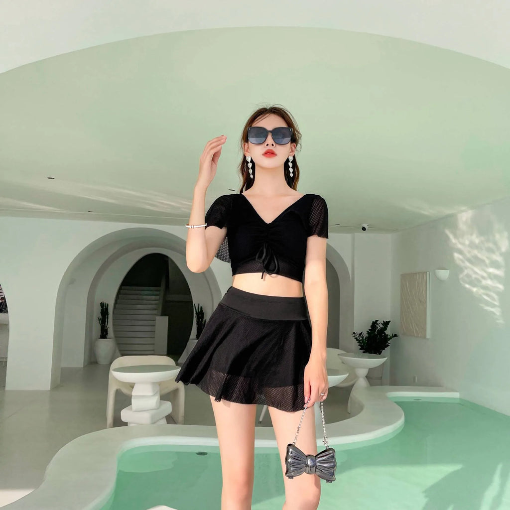 Women's solid colour two-piece swimsuit with a skirt, shown in white, black, and pink.