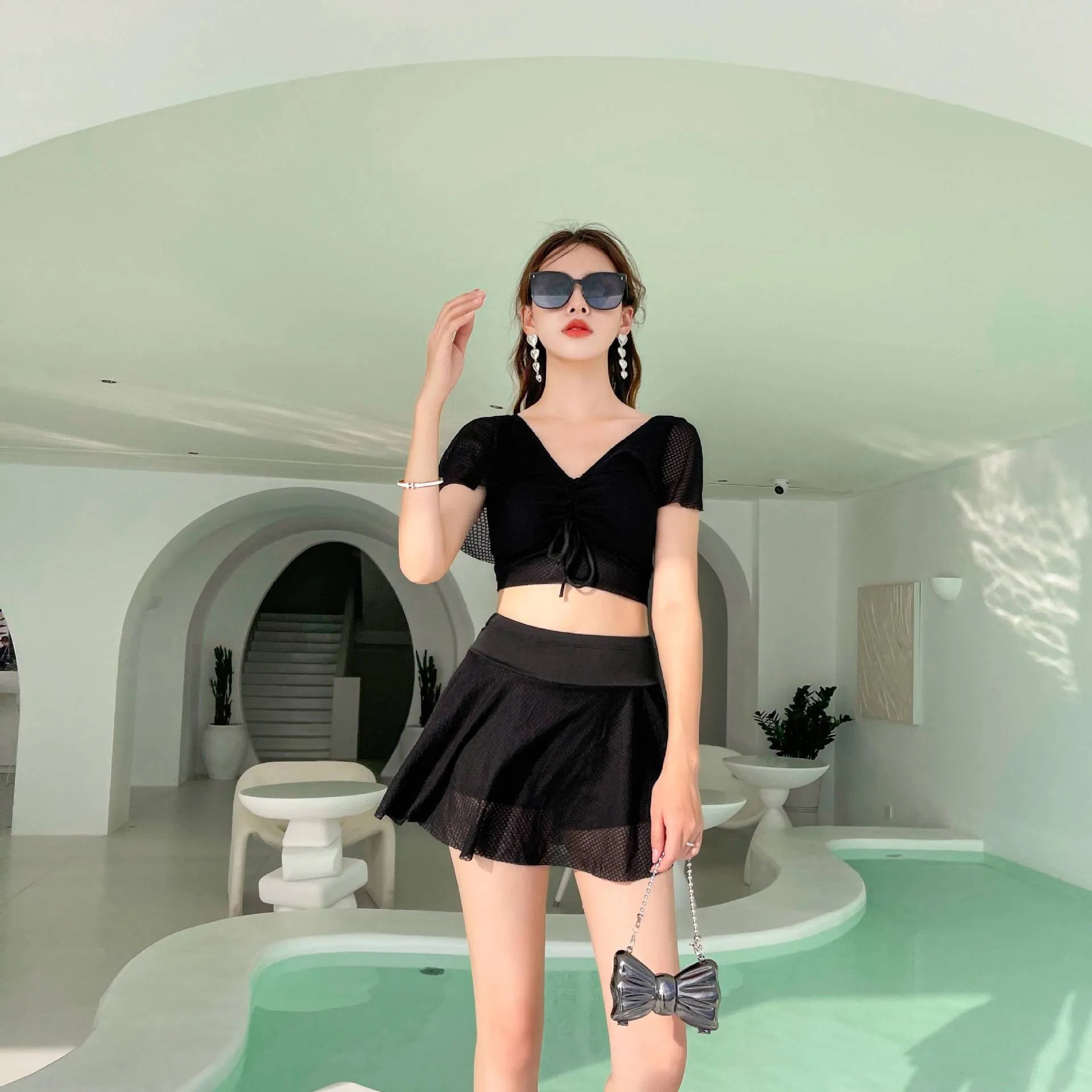 Women's solid colour two-piece swimsuit with a skirt, shown in white, black, and pink.