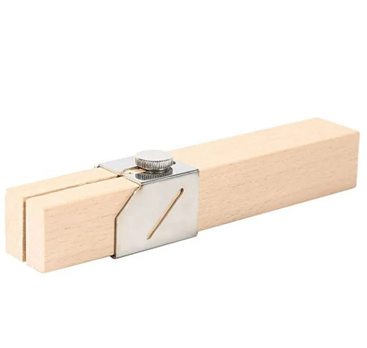 Plastic bottle cutter in log colour, 2.2 by 2.2 by 14 cm, on a table